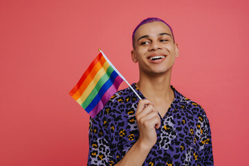 Young handsome stylish smiling happy boy holding LGBT flag