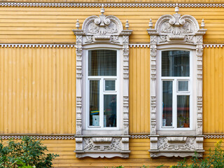 Windows of House with firebirds, Tomsk. Russian style in architecture. Wooden house, Tomsk, Russia. Beautiful carved elements of Russian Northern architecture