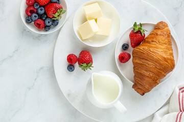 Freshly baking croissant with fresh berries