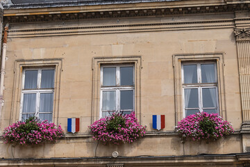 Famous historical Melun Town Hall (Hotel de Ville, 1846 - 1848). Town Hall combining neoclassical and neo-Renaissance styles, decorated with flags and flowers. Melun, France.  - obrazy, fototapety, plakaty