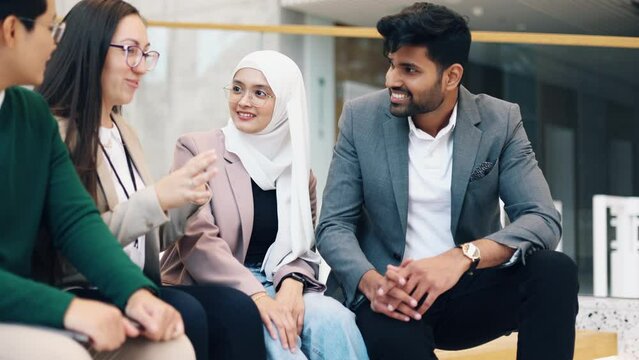Group of colleagues in an office building discussing something

