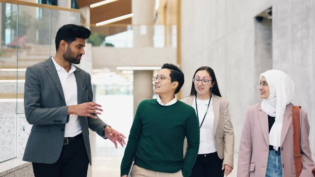 Group of colleagues in an office building discussing something

