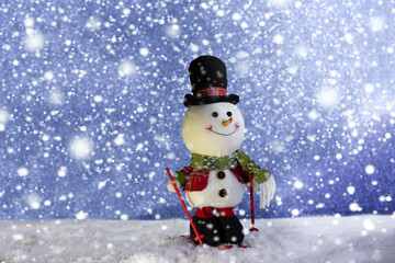 Happy snowman standing in winter sparkling christmas landscape. Merry christmas and happy new year...
