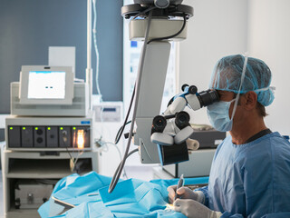 Surgeon using microscope in operating theater
