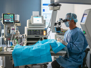 Surgeon using microscope in operating theater