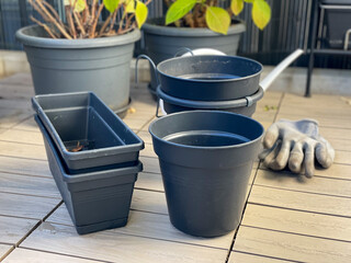 Empty flower pots and hydrangea plants in autumn time on a balcony, preparing the balcony garden...