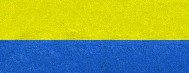 wide wall painted in yellow and blue for banner background with copy space