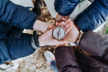 group of children holding a compass