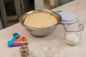 dough for bread of the dead, resting in a bowl, in a Mexican kitchen