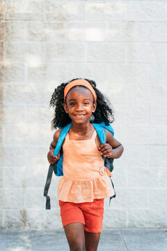 Smart African American girl with big blue backpack