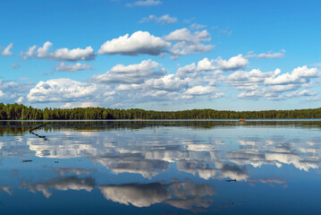 Clouds are reflected in the water surface . The Lake Is Large . Vsevolozhsk. Leningrad region.