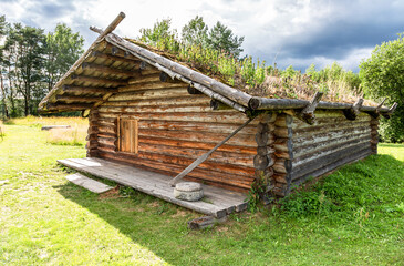Obraz premium Ancient wooden residential house in Russia. X century settlement, typical houses reconstruction