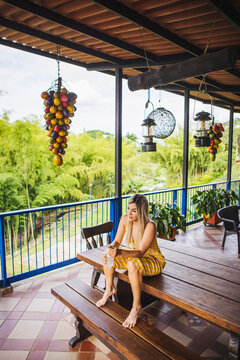 Woman sitting on table on resort terrace