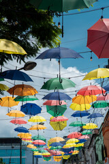 Fototapeta na wymiar Pereira, Risaralda, Colombia. February 3, 2022: The famous meeting street in the city decorated with colored umbrellas.
