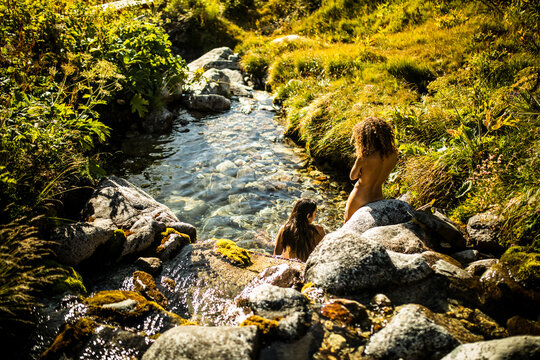 Women taking bath in mountain river