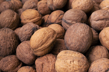 Background of walnuts close up. A full source of vegetable protein in the vegetarianism and raw food. Concept - healthy eating.