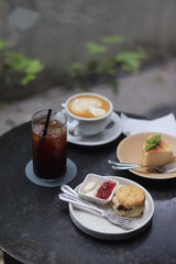A cup of latte art and bakery on the table