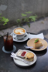A cup of latte art and bakery on the table