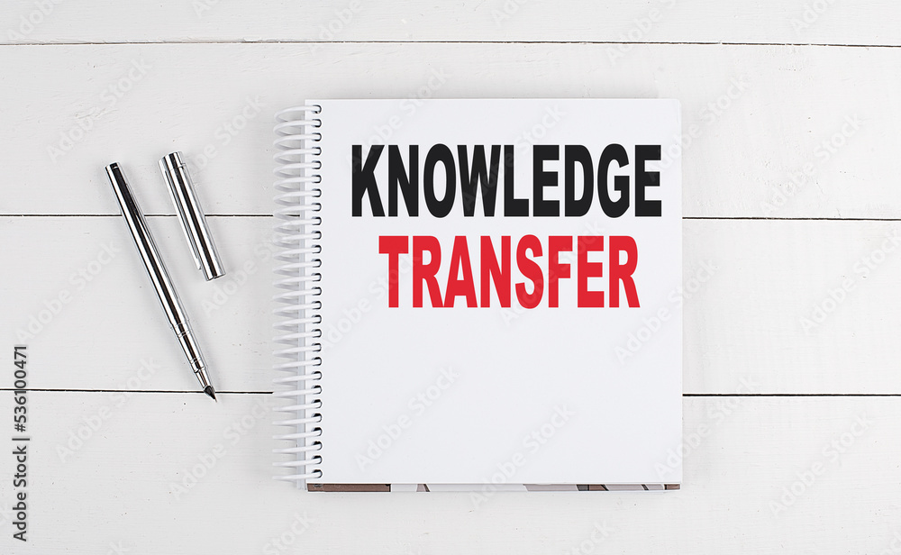 Poster knowledge transfer text written on notebook on the wooden background