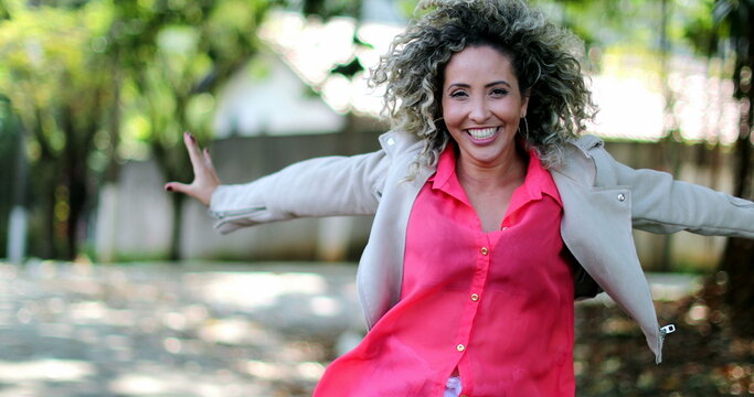 Fun Happy Person Dancing Celebrating Success. Hispanic Person Dances In Joy