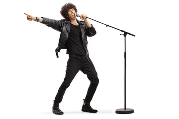 Male singer in a leather jacket singing loud on a microphone