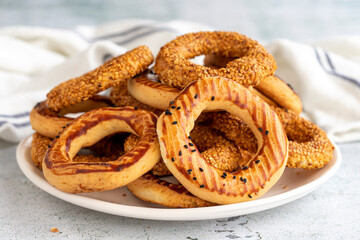 Sesame bagel on a gray background. Traditional Turkish cuisine delicacies. local name kandil simidi