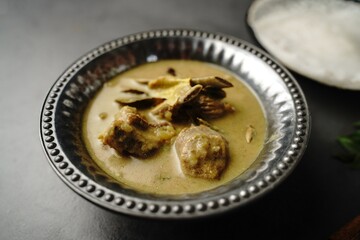 Lamb stew or Mutton in coconut milk gravy served with Appam- Kerala breakfast