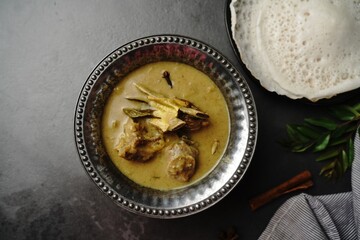 Lamb stew or Mutton in coconut milk gravy served with Appam- Kerala breakfast