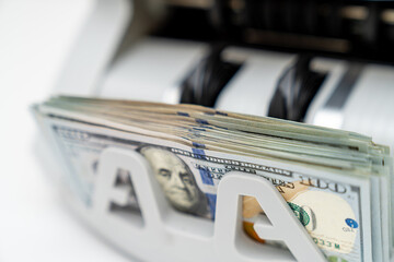 Counting dollars in banking professional machine. Bank system calculating banknotes.