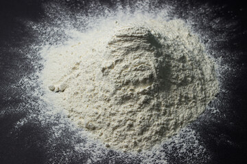 Flour on a black background. Home baking concept
