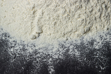 Flour on a black background. Home baking concept