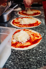 hand of chef baker making pizza at kitchen. The process of making pizza. cooking italian pizza