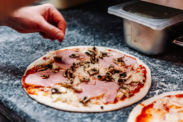 hand of chef baker making pizza at kitchen. The process of making pizza. cooking italian pizza