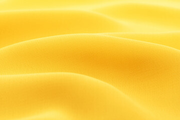 Background from yellow fabric. Material silk, satin, yellow chintz with waves