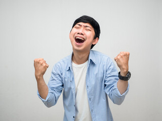 Fototapeta premium Cheerful young man satisfied happiness show fist up isolated