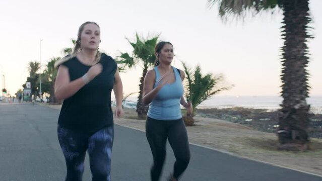 Women are running in the street, exercise, fitness and motivation for health and wellness. Diverse runners, serious, and cardio workout in urban scene for weight loss and stamina or endurance.