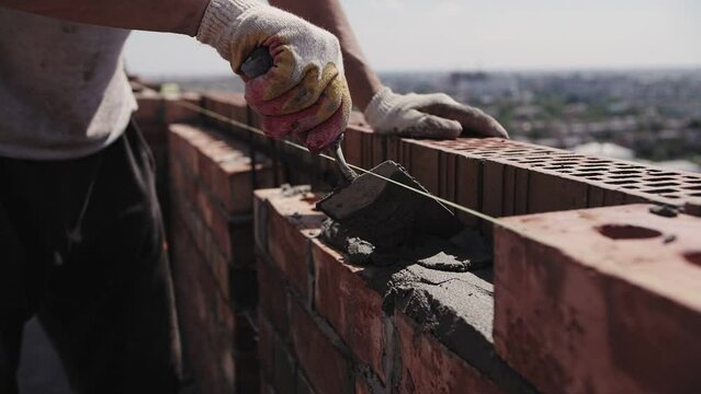 close-up of the builder hands, bricklaying