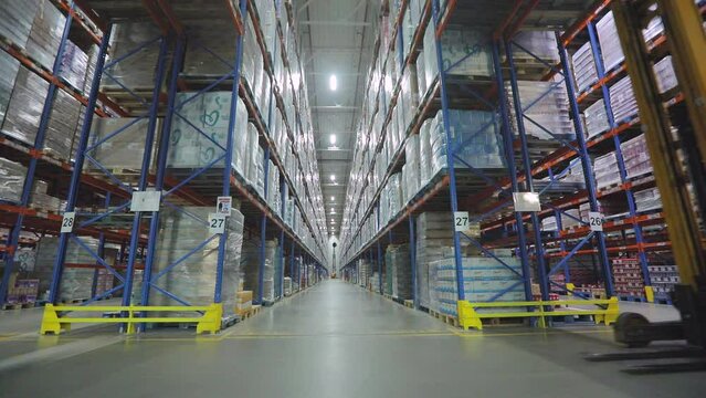 Large warehouse in the factory. High shelves in warehouse Modern warehouse. industrial interior