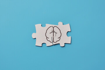 Drawing of the brain on puzzles, a symbol of the work of the two hemispheres of the brain