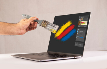 Graphic Designer painting on digital laptop screen