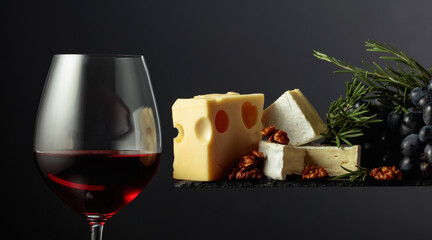 Red wine with cheese, walnuts, grapes, and rosemary.