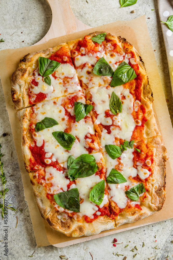 Wall mural margarita pizza at the Rome dough top view on stone table, pinsa