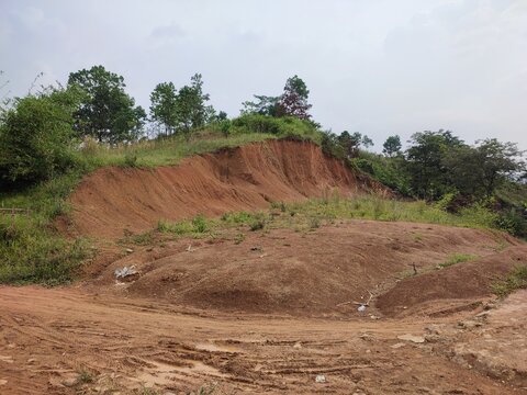photo of a landslide of red hills.