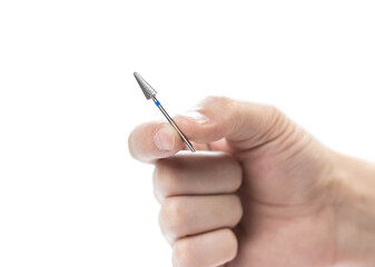 The hand holds a carbide cutter for manicure. Closeup. Isolated on a white background