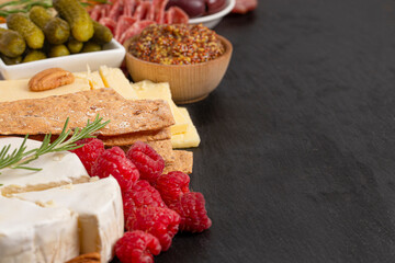 Meat and Cheese Charcuterie Board on a Black Slate Slab