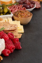 Meat and Cheese Charcuterie Board on a Black Slate Slab