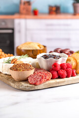 A Meat and Cheese Charcuterie Board on a Kitchen Counter