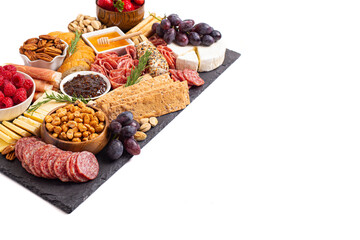 Meat Cheese and Fruit Charcuterie Board on a White Background