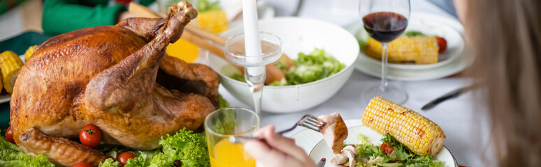 partial view of girl near traditional thanksgiving turkey with fresh lettuce, banner