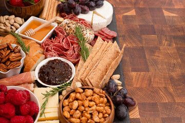 Meat Cheese and Fruit Charcuterie Board on a Wood Butcher Block